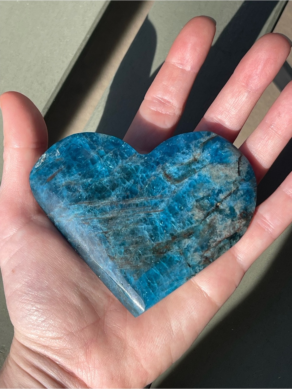 Blue Apatite Crystal Heart Carving with Blue Flash on Clear Stand